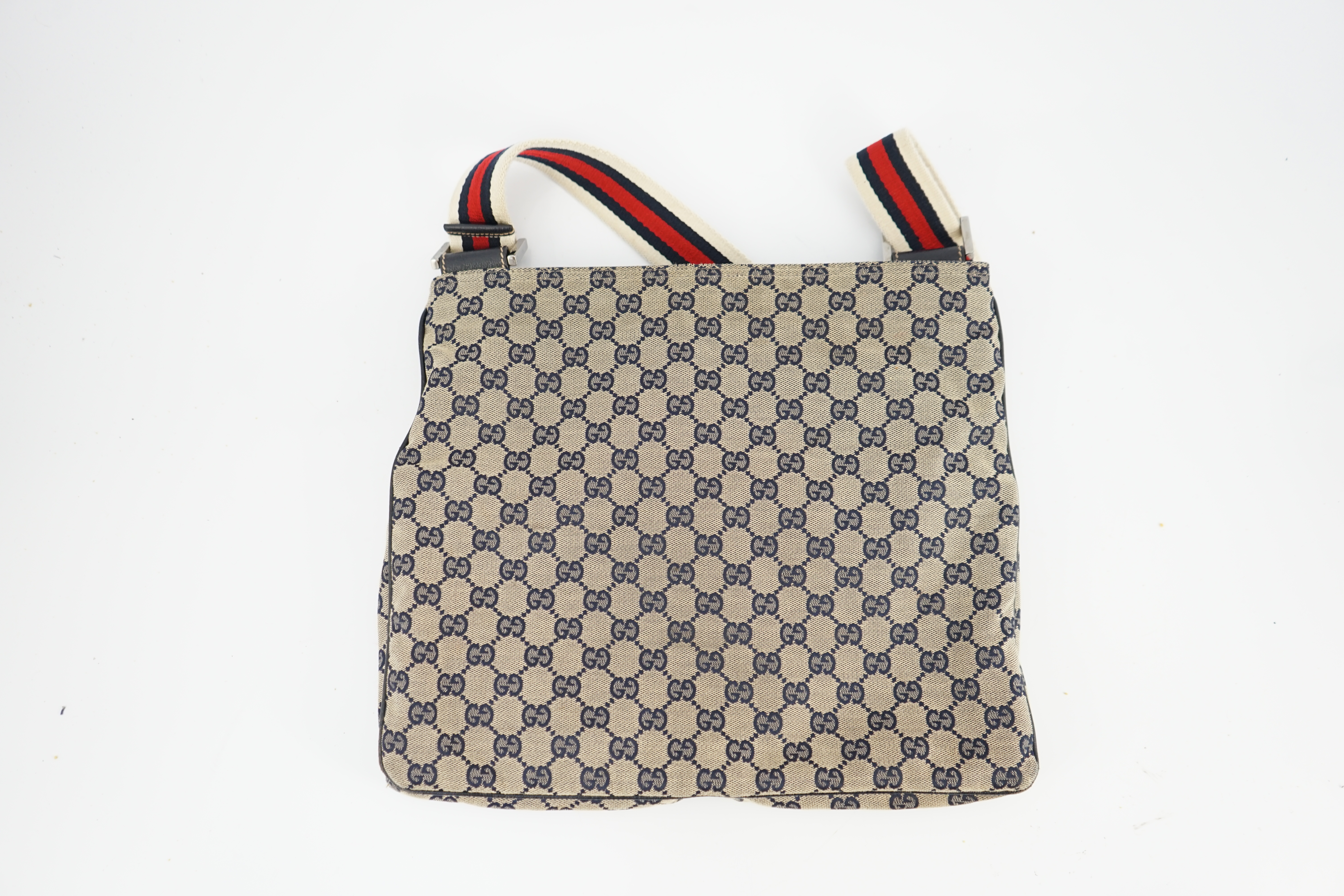 A Gucci GG monogram navy double pocket messenger bag, length 35cm depth 1cm, height 29cm